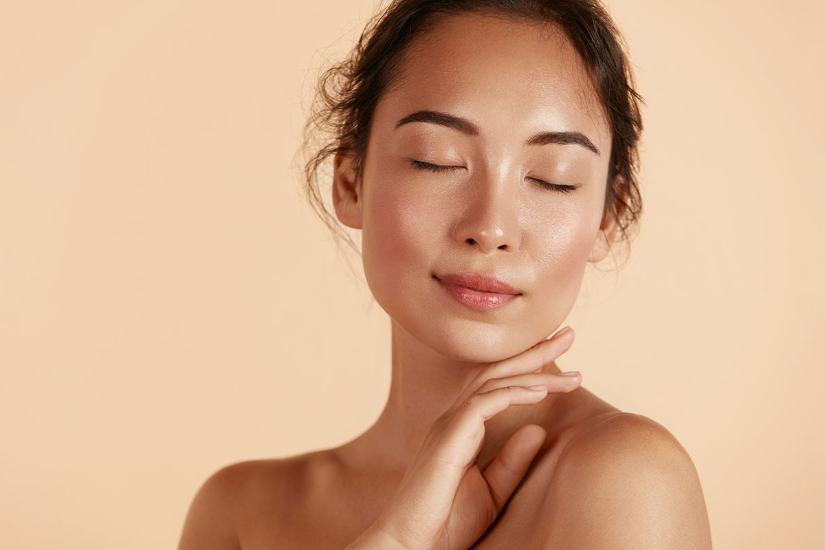 Woman with glowing skin after a facial in Chino Hills.